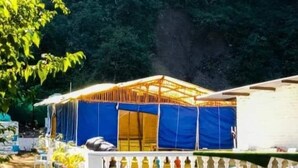 A large, open-sided structure with a blue tarp covering the sides, likely a temporary shelter or event space. - Song Valley Resort By Blue Waves (Dehradun)