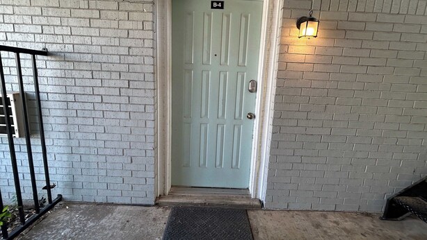 A light blue door with a number plate 'B-4' and a small step leading up to it. - Affordable & Cozy Near the Base is set in Lawton. Both free WiFi and parking on-site are accessible at the apartment free of charge! (Lawton)