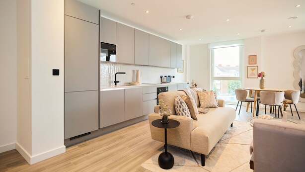 A modern kitchen with integrated appliances, a dining area with a round table and chairs, and a living room with a sofa and coffee table. - The Tottenham Escape - Lovely 2bdr Flat With Balcony (London)