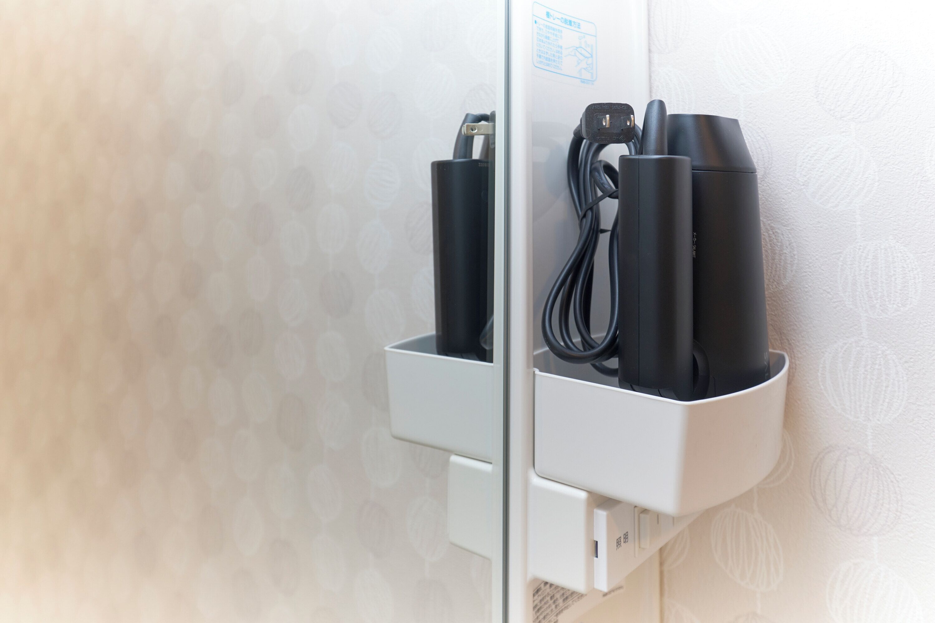 Una estación de carga de pared con toma de corriente y sistema de organización de cables.
