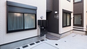 A building with a white brick exterior, black-framed windows, and a sign that reads "TOKYO SAKURA SKY". - Sky Up Oshiage by Tranova (Tokyo)