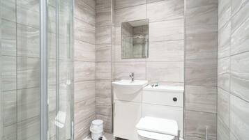 Shower, hair dryer, towels, shampoo