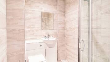 Shower, hair dryer, towels, shampoo