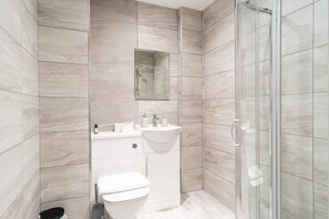 Shower, hair dryer, towels, shampoo
