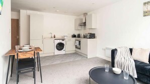 A compact living space with a kitchenette, a dining area, and a seating area. - Spacious 1 Bed Apartment in the Heart of Preston (Preston)