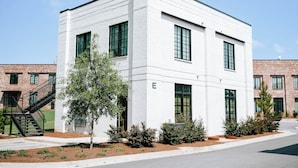 A modern white building with a flat roof, large windows, and a staircase leading to an upper level. - Cozy 1BR Home by MHM Luxury Properties (Athens)
