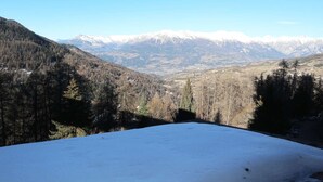 A snow-covered mountain landscape with a clear sky.