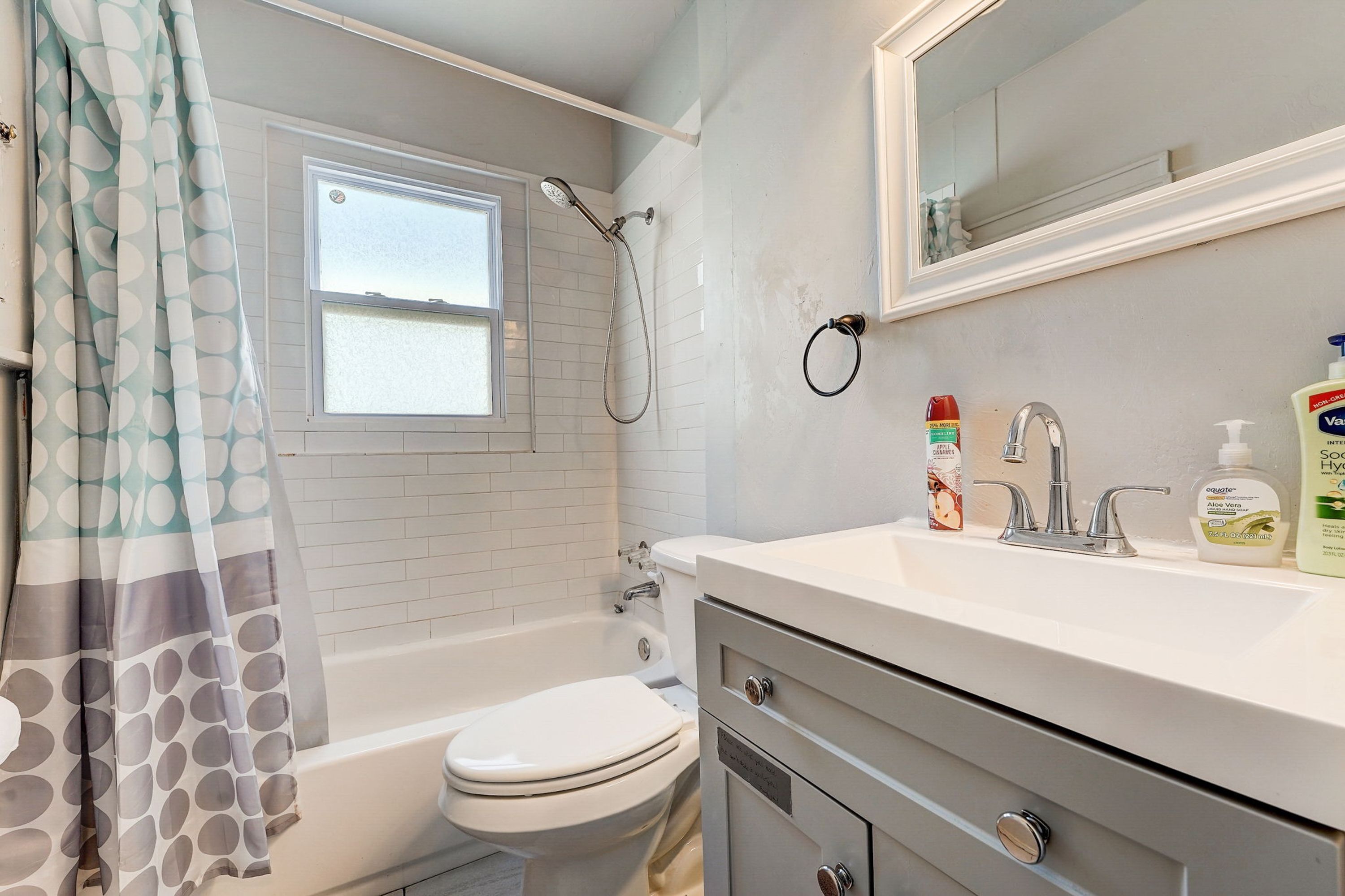 A bathroom with a bathtub, toilet, and sink.
