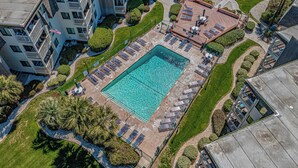 An aerial view of a hotel with a central swimming pool surrounded by sun loungers and a deck area. - Ocean Forest Villas Unit D304 - Ocean view (Myrtle Beach)