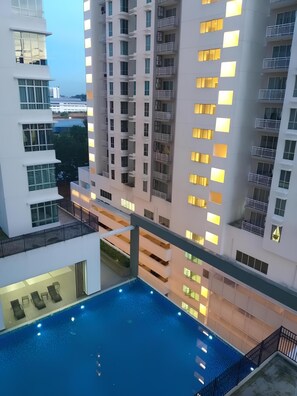 A high-rise building with multiple balconies and a swimming pool area. - Aliff Avenue 2103 By Natol (Johor Bahru)