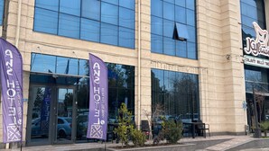 A hotel with a modern facade, large windows, and a sign for 'Aks Hotel'. - AKS HOTEL (Tashkent)