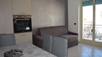 Family Apartment, Balcony, Mountain View | Living area | Flat-screen TV