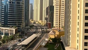 A high-rise building with a pool area and a road in the foreground. - Sparkle View Hostel (Dubai)