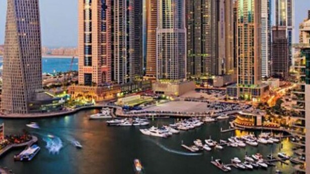 A high-rise urban area with a marina filled with boats. - Sparkle View Hostel (Dubai)
