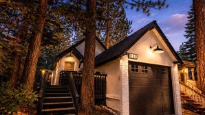 A house with a garage, a staircase, and a number '1120' on the wall. - Navigate Stays Hot Tub Home 5 Min to Ski Resort (Big Bear Lake)