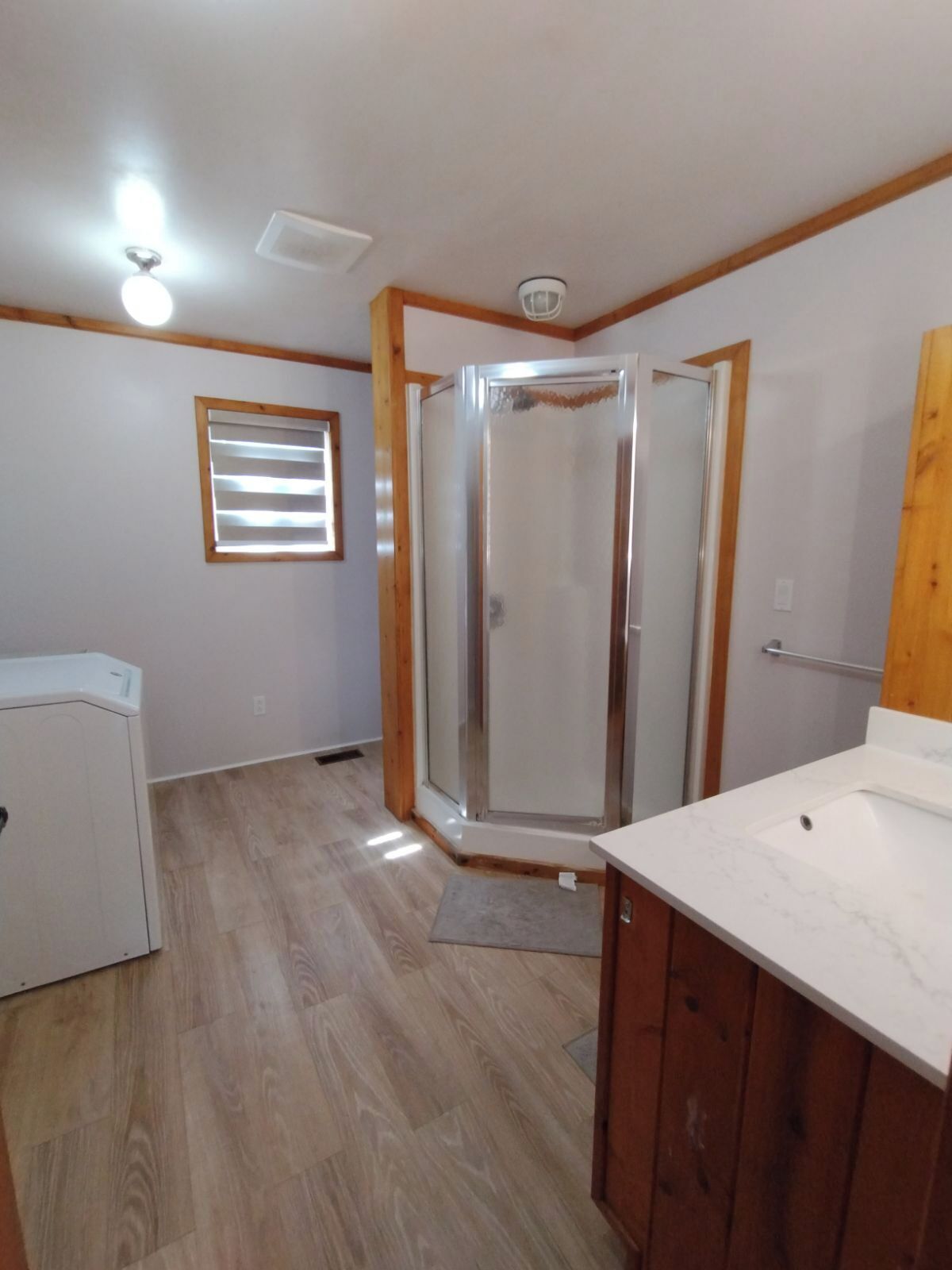 A bathroom with a shower, a sink, and a toilet.