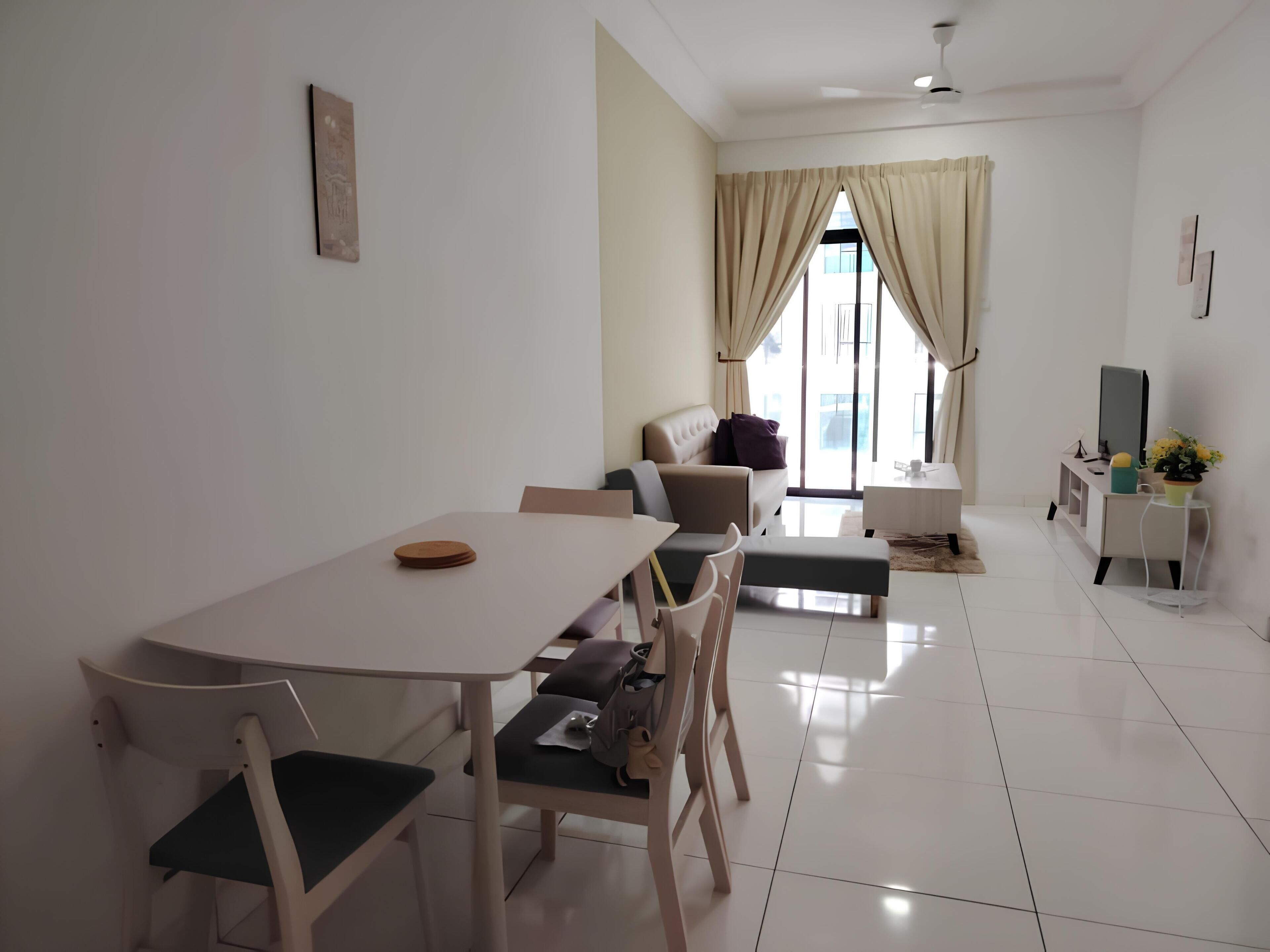 A modern living room with a dining area, a sofa, a TV, and a small table with a plant.