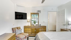 A bedroom with a bed, a dresser, a chair, and a ceiling fan. - Oceanside Condo w/ Pool & Hot Tub Access! (Oceanside)