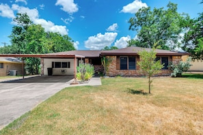 A two-story house with a garage, a covered porch, and a small front yard with a tree. - 2 Mi to Kyle Field: Bryan Home w/ Fenced Yard (Bryan)