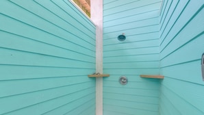 A corner of a room with teal walls and a white baseboard. - Hot Tub, Beach Access! Bay-view Gilchrist Retreat (Port Bolivar)