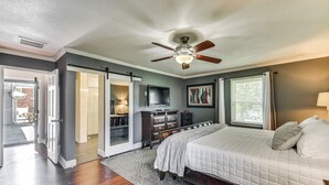 A bedroom with a bed, a ceiling fan, a television, and a window with curtains. - Luxe Lakefront Portsmouth Home: Fish, Swim & Play! (Portsmouth)