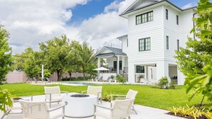 A modern two-story house with a covered patio, outdoor seating, and a swimming pool. - Larkshine House at Lunara Bay (Key West)