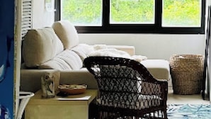 A room with a bed, a chair, a window, and a view of greenery outside. - 3-bed Artist Chalet Near San Sebastian, Sleeps 6 (Arruazu)