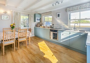 Enjoy cooking in this well-equipped kitchen with an oven, microwave, and sink.