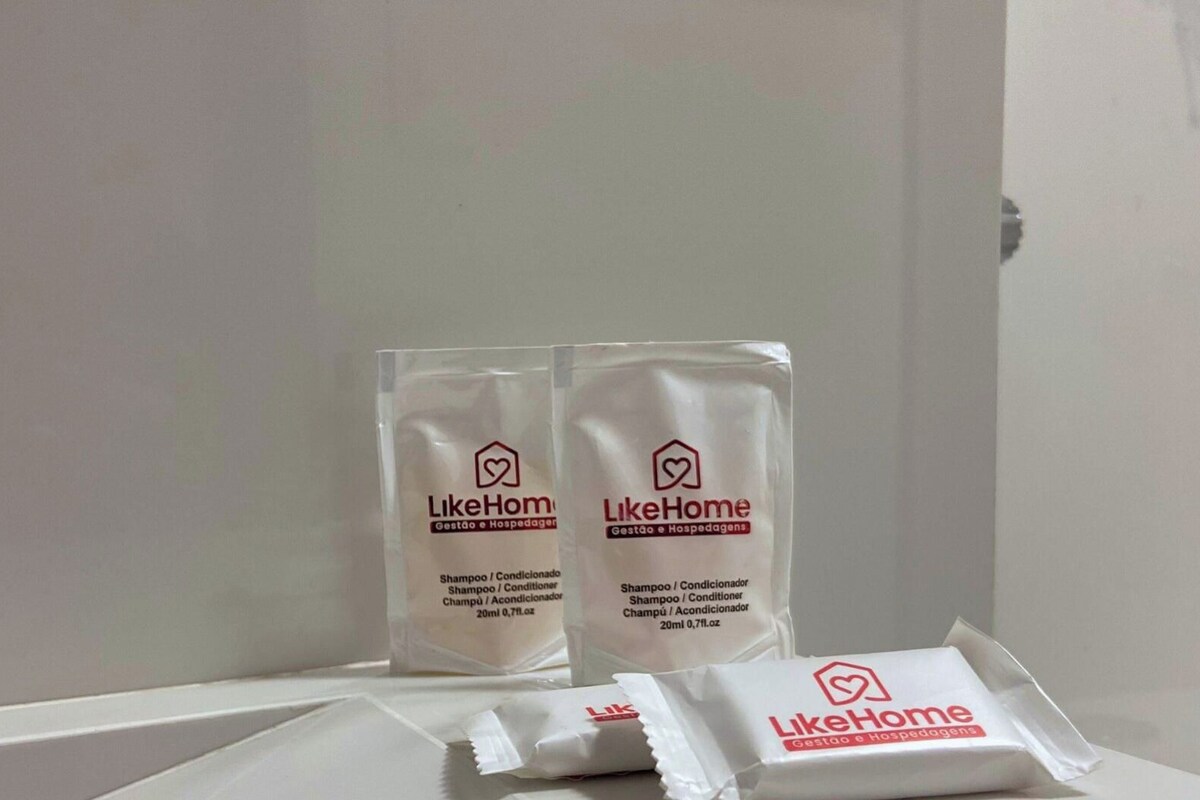 Two LikeHome branded shampoo and conditioner packages and a smaller one on a white surface.