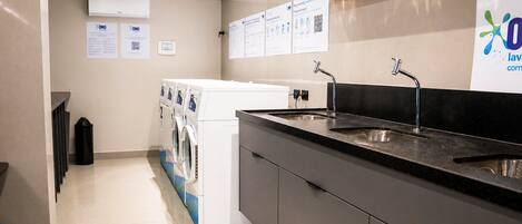 A modern kitchen with a built-in dishwasher, a sink, and a countertop.