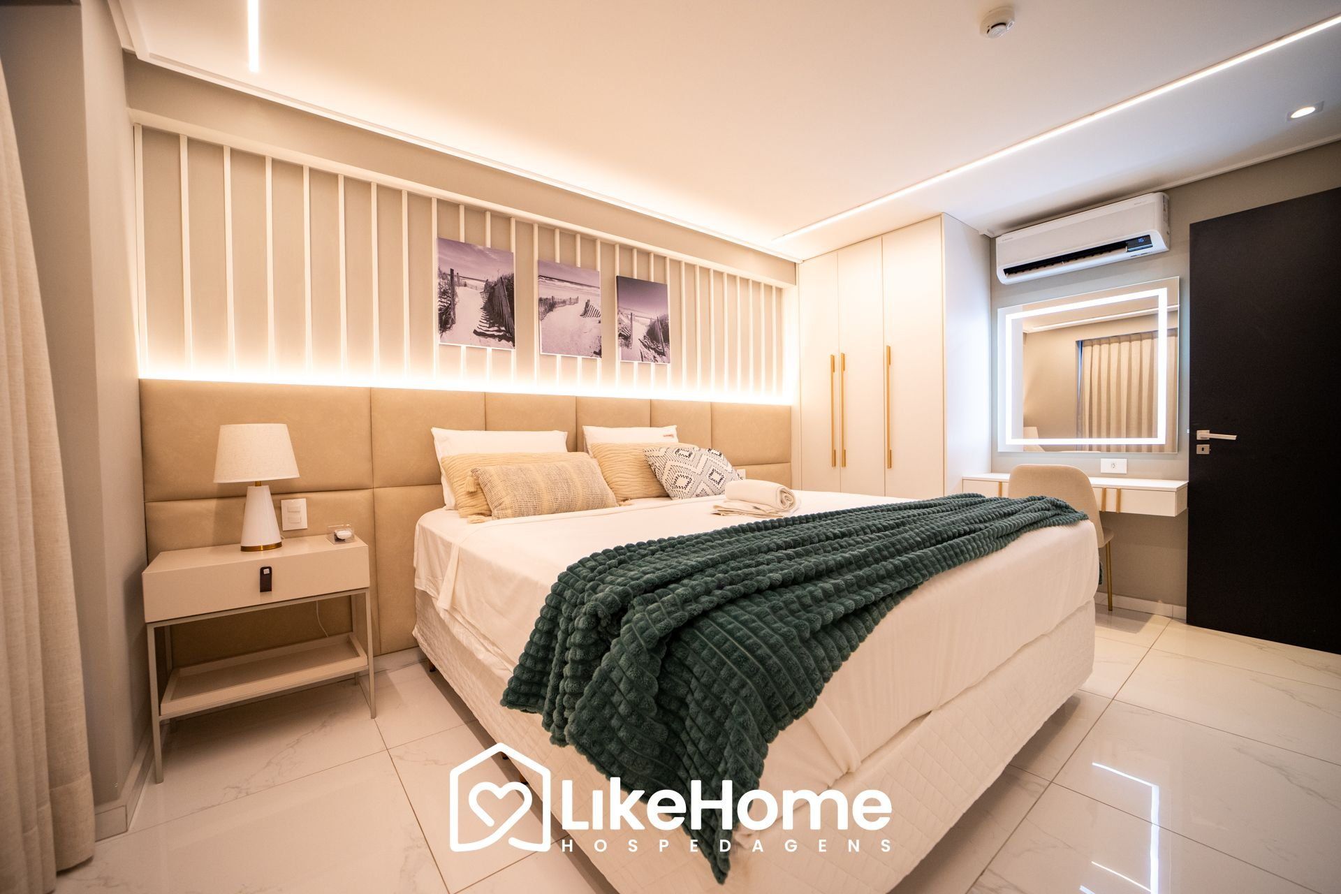 A modern bedroom with a bed, bedside table, and an air conditioning unit.