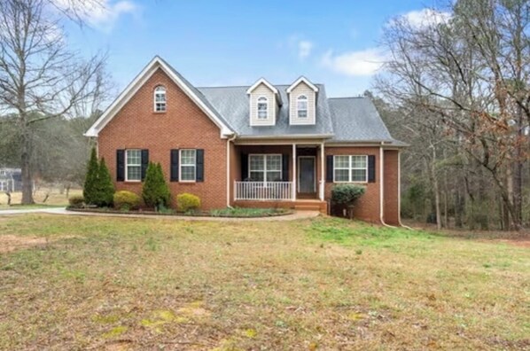 Charming single-story home with a gabled roof and inviting front porch.