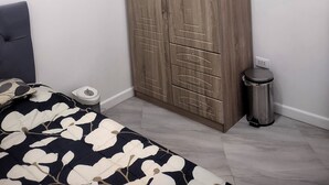 A bedroom with a wardrobe, a bed, a window, and an air conditioning unit. - New Furn 1 Br/1 Bath/Kitchen, Manila-Univ Belt, AC, Hot water, Wifi, Netflix -u2 (Manila)