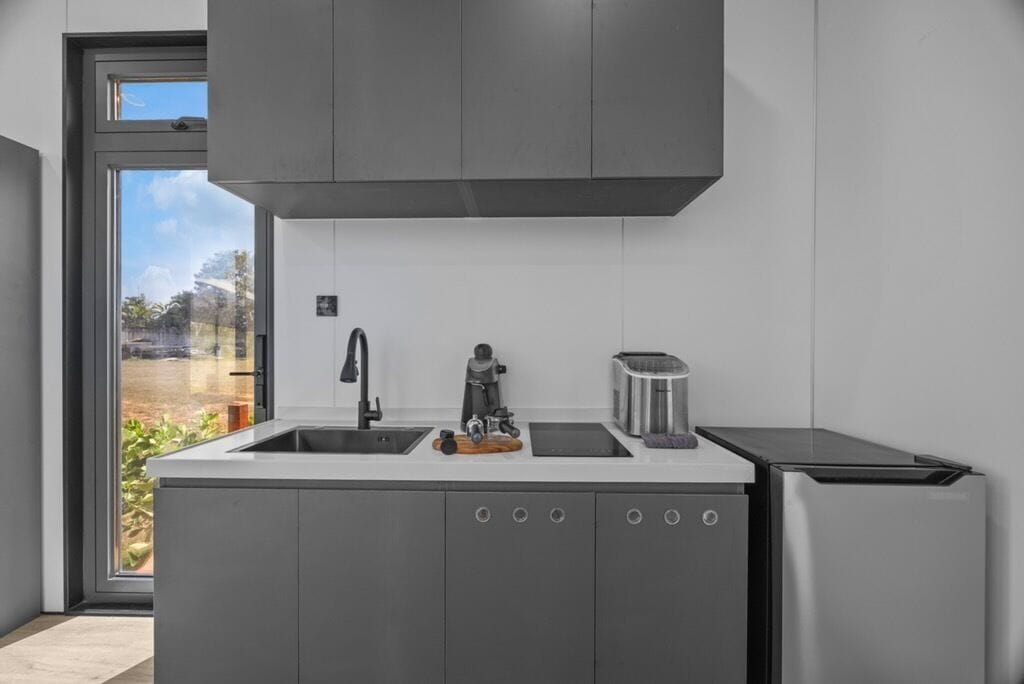 A modern kitchen with a built-in dishwasher, a coffee machine, and a toaster.
