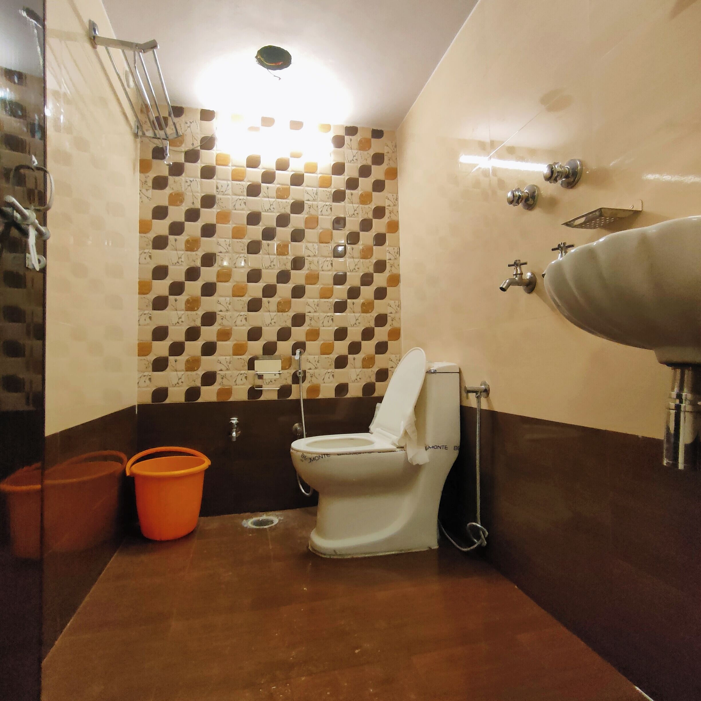 A bathroom with a toilet, sink, and shower.