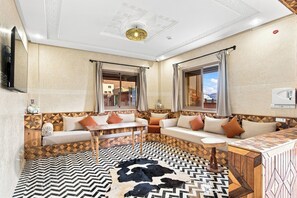 A modern living room with a sofa set, a coffee table, and a patterned rug.