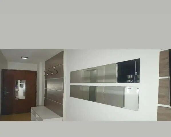 A modern kitchen with stainless steel appliances, a built-in oven, and a microwave.