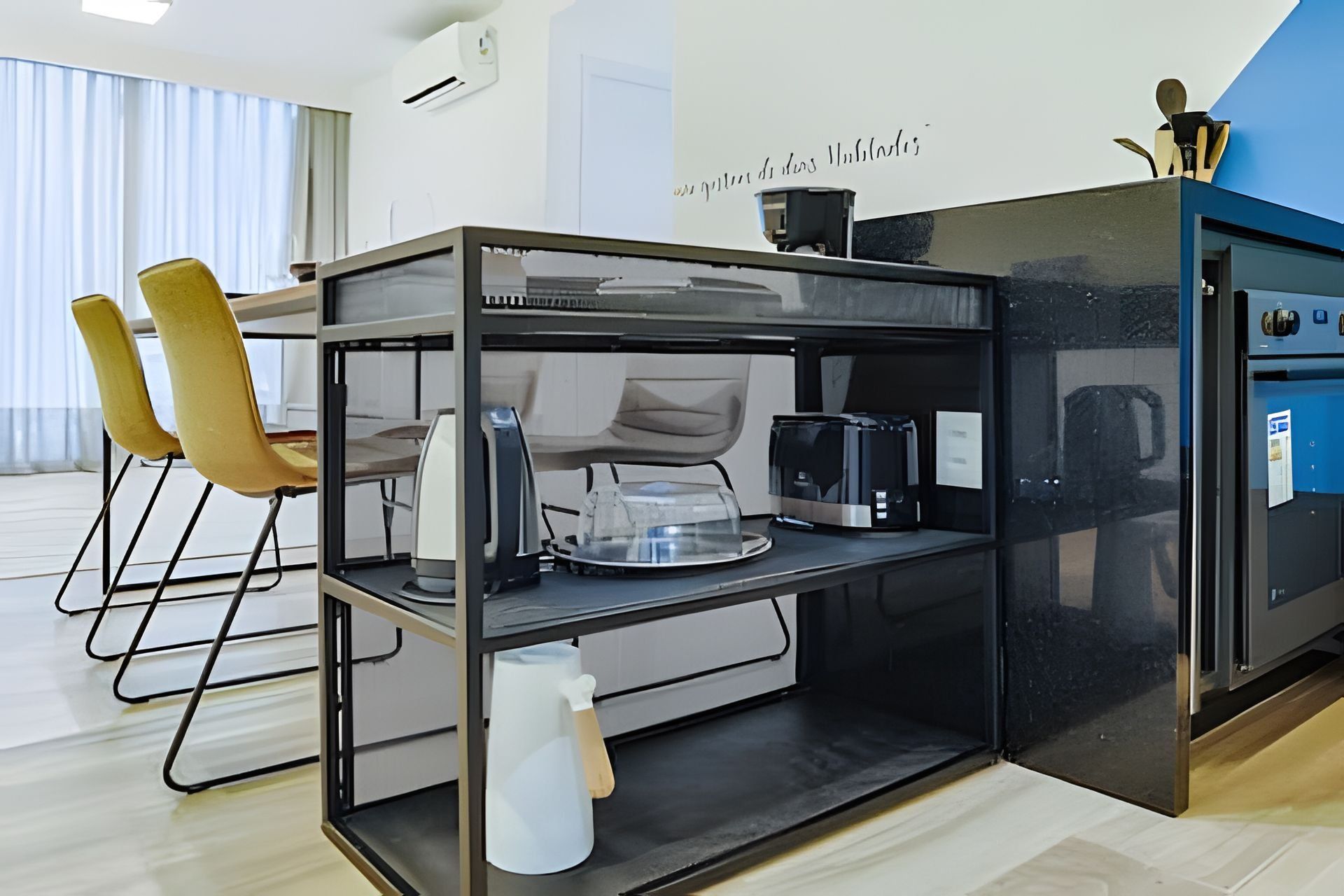 A modern kitchen with a glass-top island, a coffee machine, and a kettle.