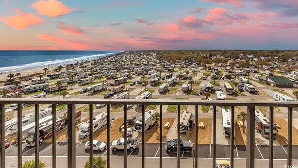 A large RV park with rows of RVs parked on a flat surface, overlooking a beach and ocean. - Flipflops & fun! Charming 2-bedroom ocean view condo at Myrtle Beach Resort (Myrtle Beach)