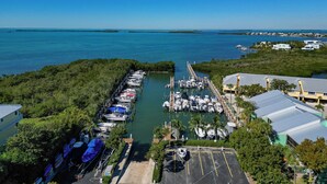 A marina with boats docked, surrounded by greenery and buildings. - Spacious 4-bedroom Key Largo Villa steps from the pool, pickleball, & marina.  (Key Largo)