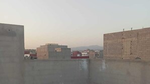 A rooftop terrace with a tiled floor and a view of surrounding buildings. - Tranquil Rooms in Agadir (Agadir)