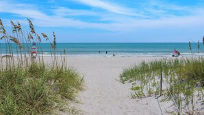 A beach with a lifeguard tower, sandy shore, and ocean view. - 4BR Waterfront Retreat - Private Dock, Kayaks, Hot Tub & Tiki Bar  Walk to Beach (Cocoa Beach)