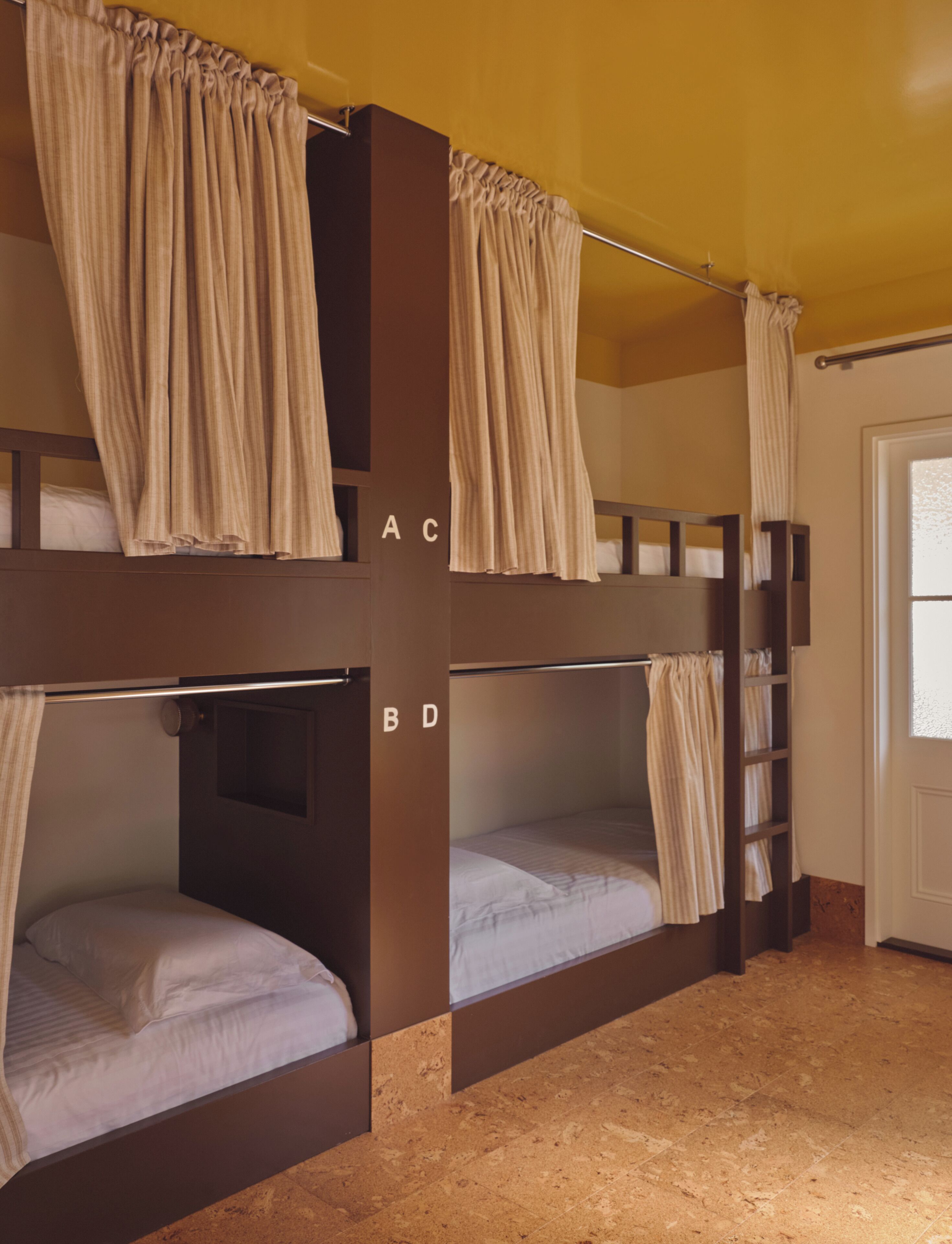 A bunk bed room with curtains, labeled with letters A, B, C, and D.