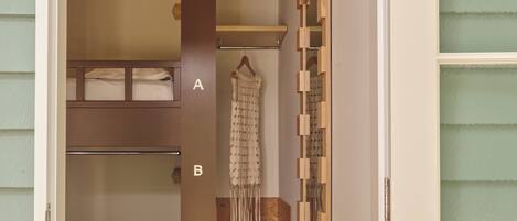 A compact room with bunk beds, a wardrobe, and a decorative wall.