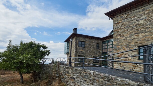 Um edifício de pedra com uma escadaria que leva a um portão.