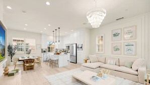 A modern kitchen with white cabinets, a central island, and stainless steel appliances. - Modern Grand Luxury Estate in Irvine with Pool & Amenities  (Irvine)