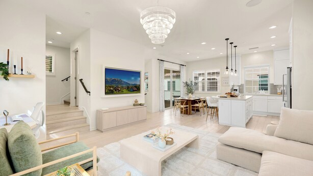 A spacious living area with a modern kitchen, a dining area, and a staircase leading to another level. - Modern Grand Luxury Estate in Irvine with Pool & Amenities  (Irvine)