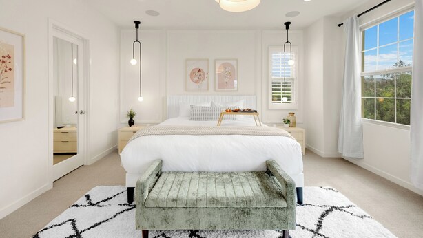 A spacious bedroom with a large bed, bedside tables, a bench, a window with curtains, and artwork on the walls. - Modern Grand Luxury Estate in Irvine with Pool & Amenities  (Irvine)