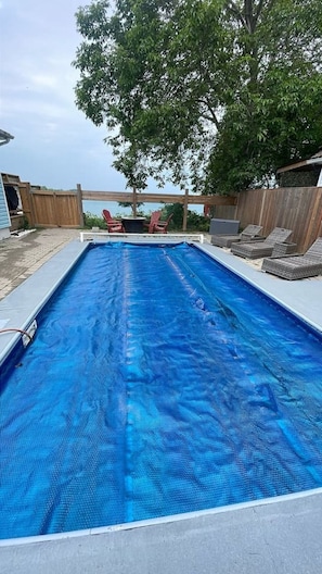 Guests can enjoy a refreshing swim in the pool surrounded by a wooden deck.