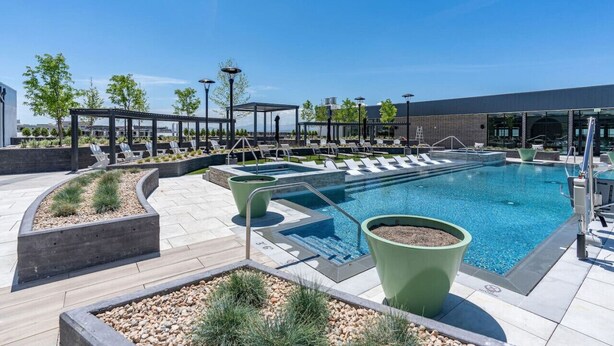 A swimming pool area with lounge chairs, a covered seating area, and a landscaped garden. - Downtown Luxury 1BD- Pool/Spa/Bowl/Golf/Gym/Parkng (Salt Lake City)